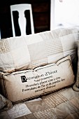 Scatter cushion with printed lettering on seat cushion