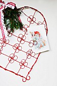 Red, wire ornamental heart with clips for displaying Christmas cards