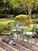 Ornate bistro table and turquoise chairs on rustic terrace seating area