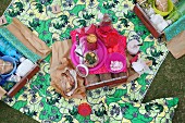 Picnic in garden with individually packed wooden crates used as picnic hampers