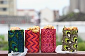 Cornbread for a picnic baked in tin cans & wrapped in colourful print fabrics