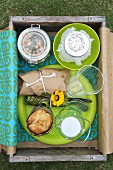 Drinks & food for picnic in wooden crate