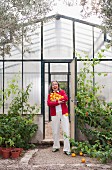 Woman harvesting fruit in greenhouse