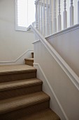 Close-up of stairs with white walls