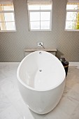 White free-standing bathtub in contemporary bathroom