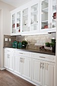White cabinets and glass cabinets in kitchen