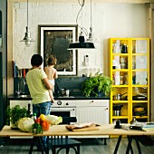 Father holding son in kitchen