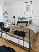 Velvet and silk bed line in black and taupe on ornate metal bed and matching cot in background