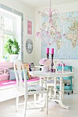 Pink chandelier above white dining set and bench below window