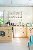 Bright, country-house-style kitchen with L-shaped counter and island counter