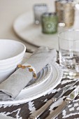 Place setting with white china plate and linen napkin