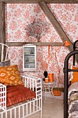Throne-style armchair with orange cushions in front of half-timbered wall with wallpaper panels, retro standard lamp and white, glass-fronted cabinet