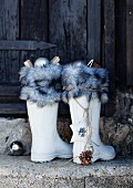 Christmas decorations in white wellingtons with fur trim as alternative Saint Nicholas boots