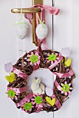Easter door wreath made from willow branches decorated with satin ribbons, felt flowers & wooden flowers