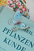 Paper butterfly on antiquarian plant book