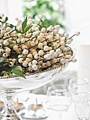 White artificial berries in silver dish