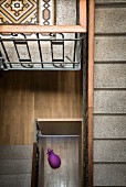 Traditional stairwell with terrazzo treads and view of purple animal sculpture