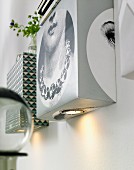 Homemade wall lights made from boxes and spotlights covered with various types of wallpaper