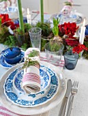Blue and white place setting with napkin on festively set table