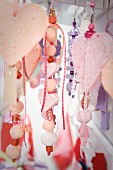 Collection of threaded, suspended decorative hearts and beads