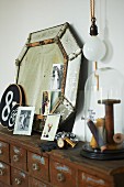 Vintage mirror and flea market finds on old apothecary cabinet