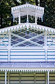 Blue and white striped summer house with diamond lattice window and Oriental-style roof ornament