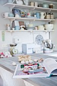 Bulbs of garlic and open cookery book in romantic, vintage kitchen