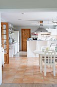 Open-plan kitchen with white dining set