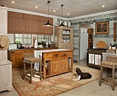 Rustic, country-house kitchen - dog on rug in front of free-standing kitchen counter