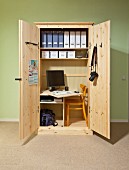 Office in a cupboard: open, custom-made cupboard with integrated desk, shelves and chair