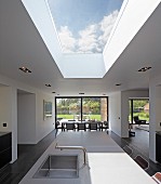 Point 7, Winchester, United Kingdom. Architect: Dan Brill Architects, 2014. Open-plan interior with skylight over kitchen island with dining area in background