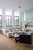 Bright interior with sofa, retro leather armchair and delicate coffee tables