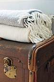 Old trunk with brass fittings and wool blankets on top