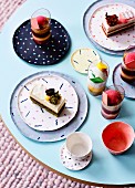 Desserts and cakes in glasses and on patterned plates on coffee table