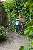 Bicycle leaning against brick house wall