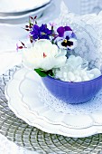 Place setting decorated with spring flowers & doilies