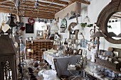 Cluttered shop selling vintage-style home accessories in restored country ouse