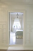 View through open door into grand bedroom