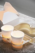 Tealights in paper cups in to-go tray and take-away carton