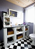 Washstand with masonry base against lilac-painted walls in bathroom with diagonally chequered floor