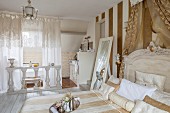 Elegant bedroom with ensuite bathroom decorated by white balustrade and lace curtains