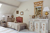 Elegant, antique furnishings and accessories in attic bedroom