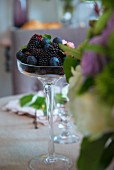 Blueberries and blackberries in stemmed glass