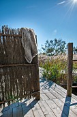 Rustic wooden frame covered with straw mats on wooden terrace