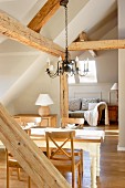 Wrought iron chandelier in attic with exposed wood-beam structure