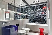 Designer bathroom in shades of grey with red accents
