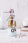 Spiced oil in a decoratively sprayed gift bottle