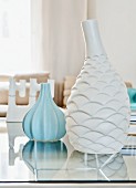 White and pale blue vases with structured surfaces