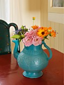 Bouquet in blue-grey teapot; rustic ambiance