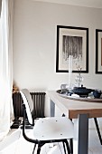 White-painted, retro-style wooden chair at modern dining table with solid-wood top